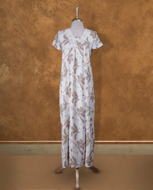 White colour NStyle nighty featuring brown floral patterns, a V neckline with lace detailing, short sleeves, and a full ankle-length design
