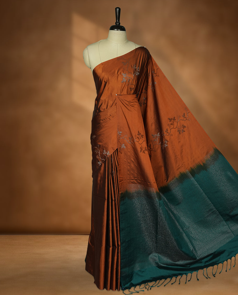 Brown colour soft silk saree featuring Antique zari motifs on body with Highlighting contrast green colour pallu and paired with matching blouse piece.