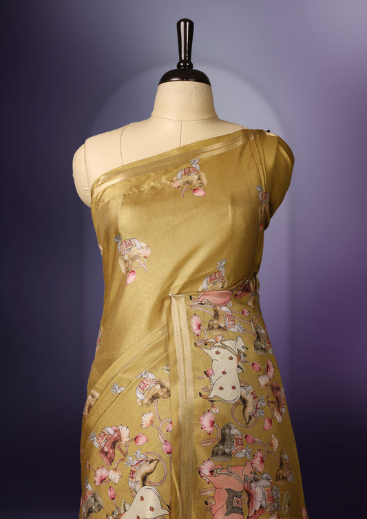 Medallion yellow color saree adorned with charming pastel floral and figure prints all over the body and pallu, lending a whimsical touch & The soft sheen adds elegance, and its paired with a matching blouse piece.