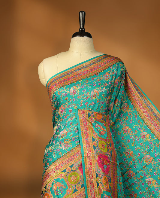 Aqua green colour Pashmina silk saree densely woven with intricate multicolour floral kodi pattern across the body, framed by an opulent arabesque border and grand storytelling pallu, paired with a matching woven border blouse piece