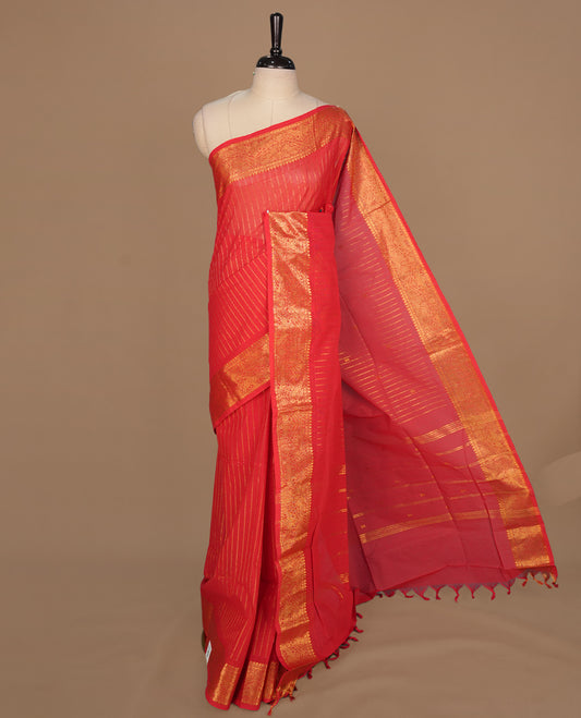 Red colour chettinad cotton saree featuring gold zari stripes on body, self colour with zari border, paired with matching blouse piece.