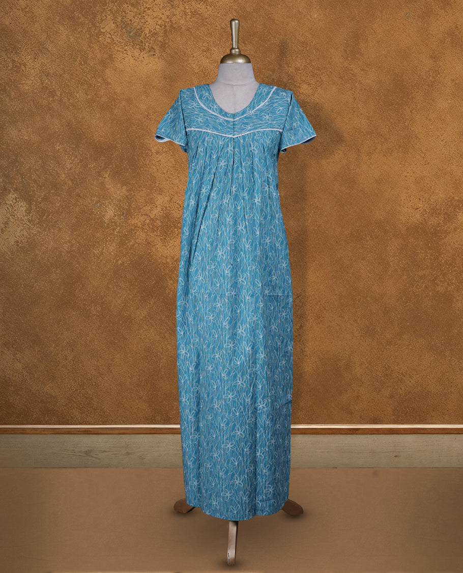 Aqua blue colour NStyle nighty featuring white patterns, a V-neckline with lace detailing, short sleeves, and a full ankle-length design.