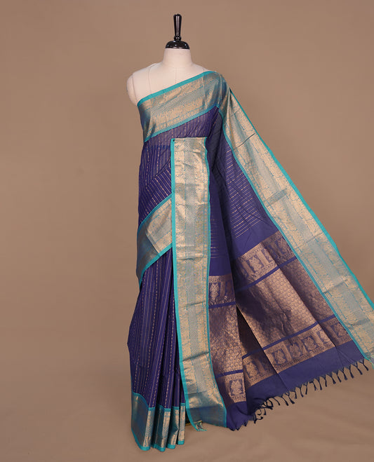 Navy blue colour chettinad saree featuring gold zari stripes on body, complemented by contrast Aqua colour with traditional border, paired with matching blouse piece.