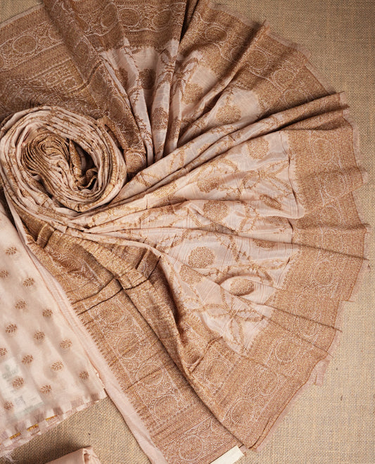 Elegant beige colour suit material adorned with subtle golden designs, exuding timeless charm & Paired with a beautifully woven dupatta and a matching plain bottom.