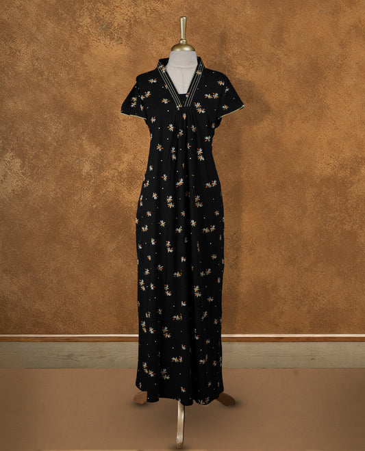Black colour Nstyle nighty with featuring a floral pattern, a V neckline with yellow theard detailing, Short sleeve, and a full-length