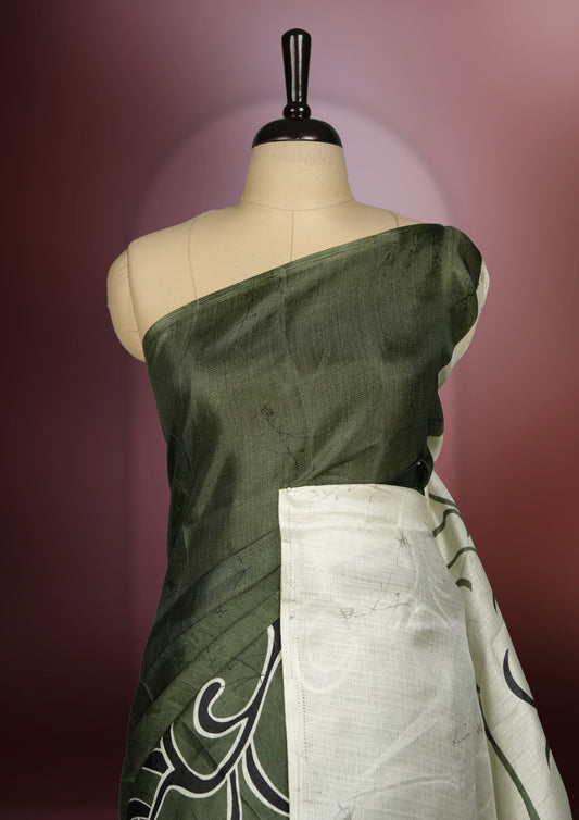 Olive green colour saree with striking off white floral patterns, merging modern minimalism with timeless charm & paired with a matching blouse.