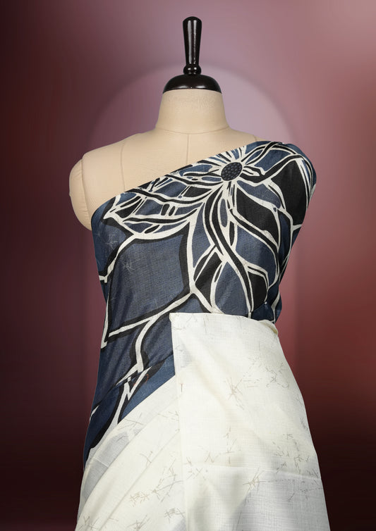 Grey and off white colour saree adorned with striking abstract floral designs, offering a perfect fusion of elegance and contemporary charm & paired with a matching blouse.