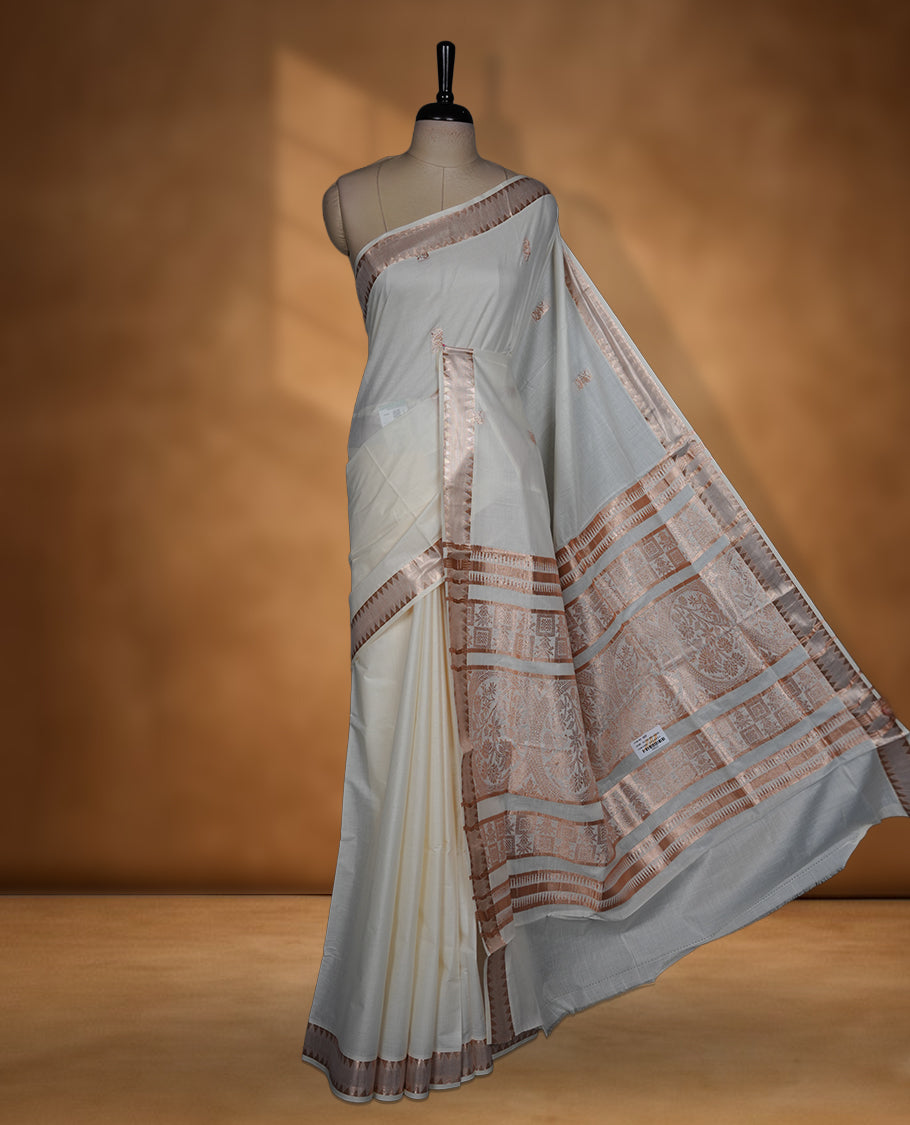 Off white colour cotton Kerala saree featuring a Plain body, a refined light copper zari border, and an intricately woven traditional pallu, paired with a matching blouse.