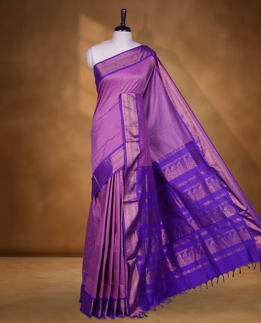 Lavender colour kalyani cotton saree featuring Antique zari check pattern on body, contrast Indigo colour border with antique zari pattern, paired with matching blouse piece.