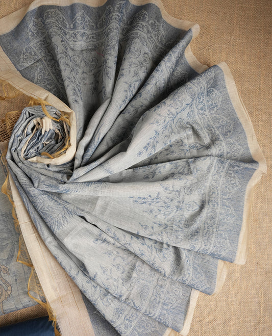 Beige & Blue colour suit material adorned with intricate woven patterns, bird print & subtle motifs, exuding ethnic grace & paired with a beautifully bordered dupatta and a matching plain bottom.