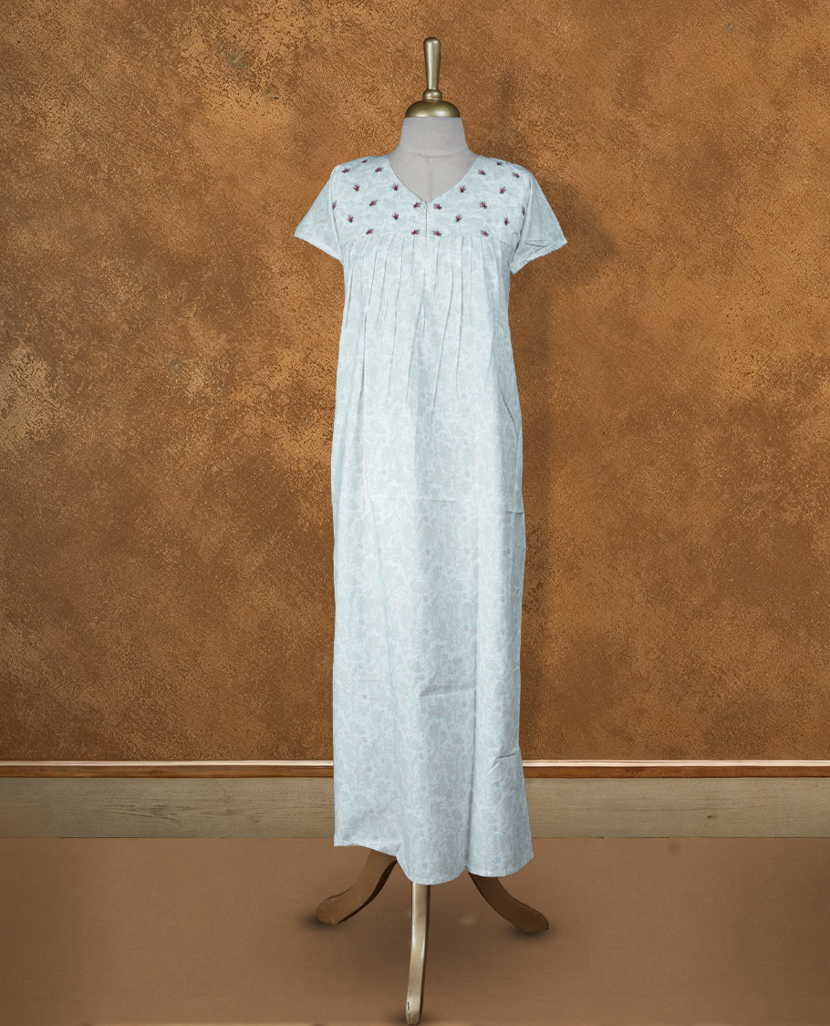 Off White colour NStyle nighty featuring  greenish white floral patterns, a V-neckline, short sleeves, and a full ankle-length design.