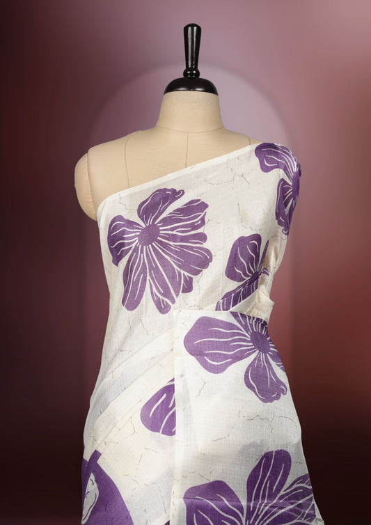 Off white colour semi khadi silk saree with light violet floral motifs and subtle , exuding timeless elegance and modern charm & paired with a matching blouse.