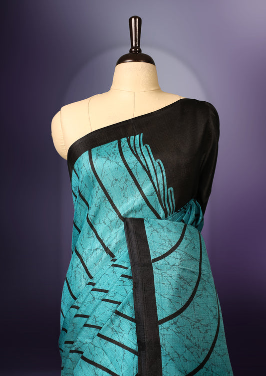 Elegant teal and black saree with abstract stripes and tassel detailed pallu & Perfect for festive and party occasions. Includes unstitched blouse piece. Style with minimal jewelry for a chic look.