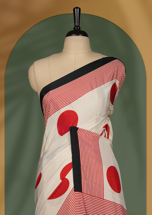 Ivory colour saree with bold red polka dots and contrasting black red striped pallu & Comes with a stylish matching blouse.