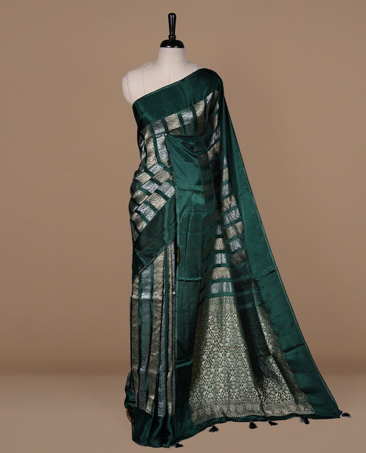 Green colour banaras crepe saree featuring gold & silver zari design stripes on body, complemented by self colour border, paired with matching blouse piece.