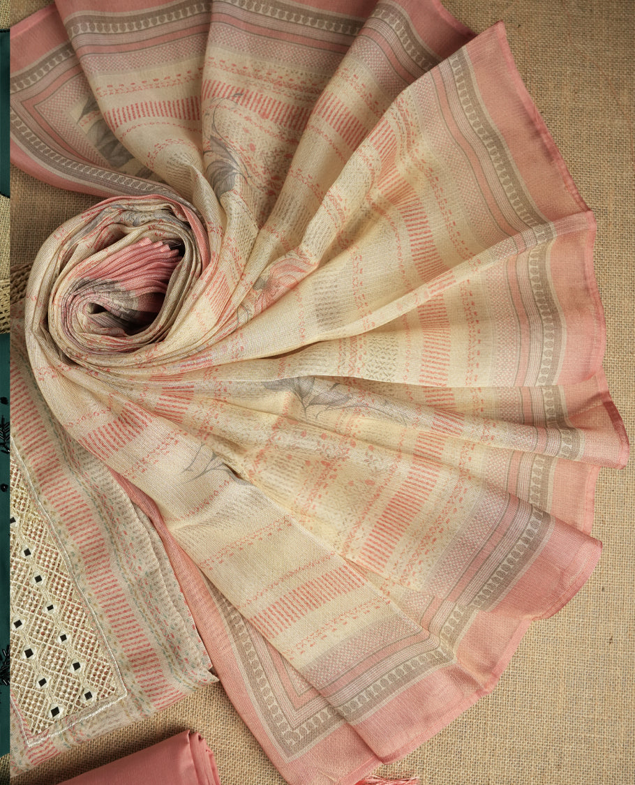 Pastel peach and beige colour suit material with delicate woven mirror work patterns and subtle zari detailing & Includes a soft dupatta with a floral touch and plain matching bottom.