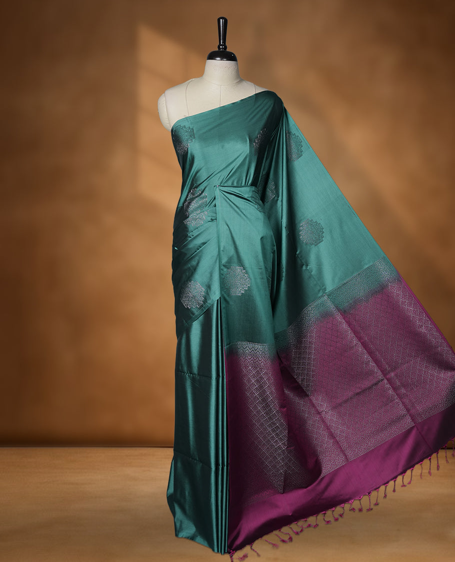Cadmium green colour soft silk saree featuring Antique zari motifs on body with Highlighting contrast Pink colour pallu and paired with matching blouse piece.