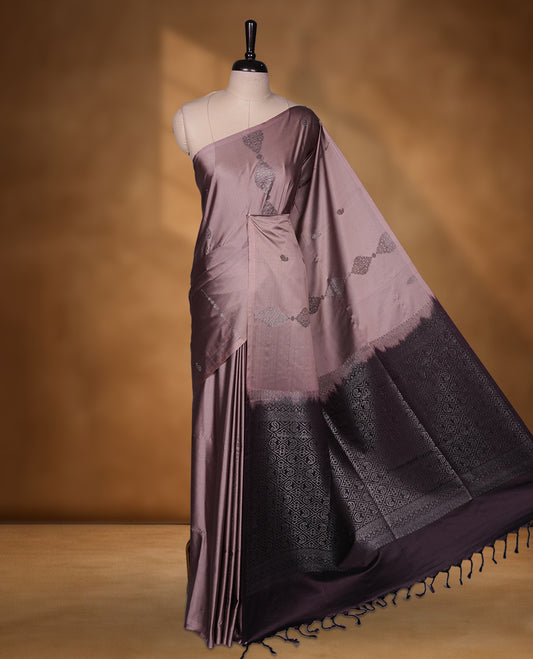 Old rose colour soft silk saree featuring Antique zari motifs on body with Highlighting contrast wine colour pallu and paired with matching blouse piece.