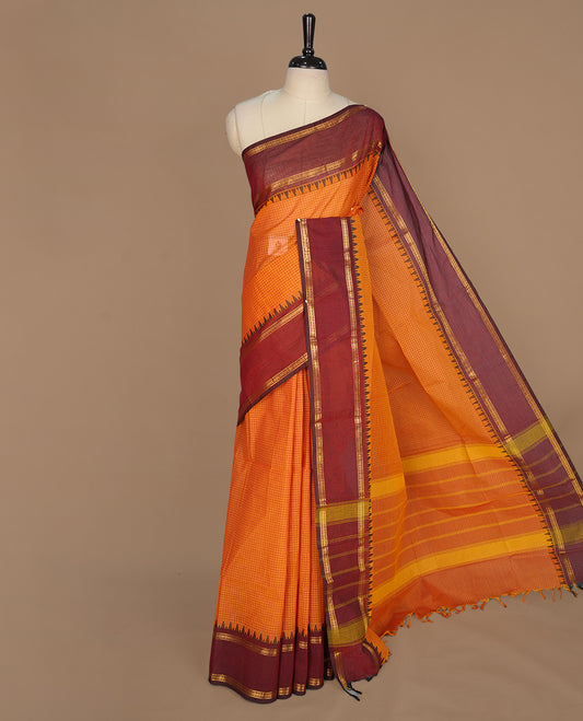 Tangerine colour chettinad colour featuring check pattern on body, complemented by maroon with zari border, paired with matching blouse piece.