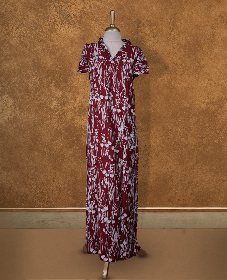 Dark Red colour Nstyle nighty with featuring a White floral pattern, a V neckline with black theard detailing, Short sleeve, and a full-length