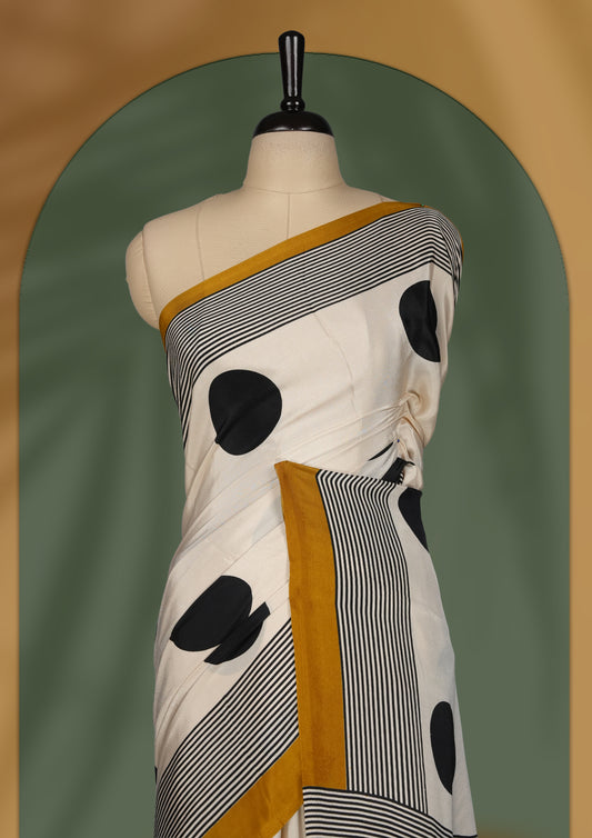 Cream colour saree with bold black polka dots, fine striped design, and mustard yellow borders & Paired with a matching blouse.