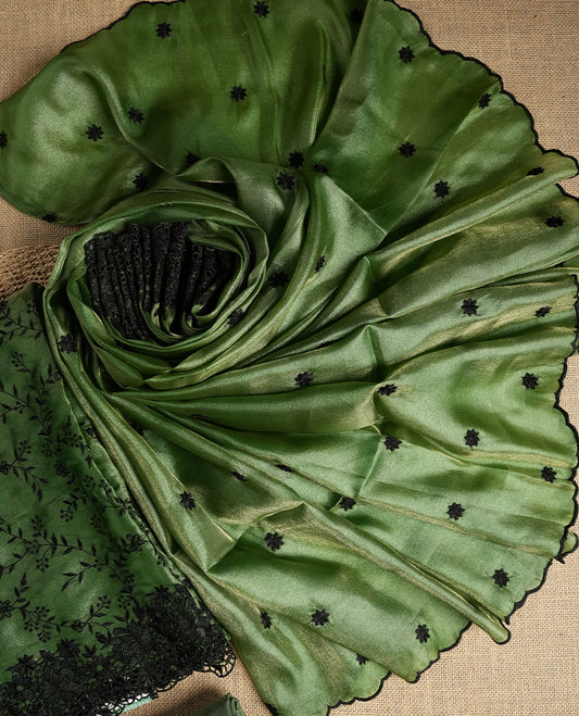 Rich Green colour dual shaded suit material with delicate black floral embroidery and lace border & Includes matching dupatta with embroidered motifs and plain bottom fabric.