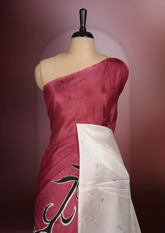 Vivid maroon colour saree adorned with bold off white floral prints, blending tradition with a modern twist & paired with a matching blouse.