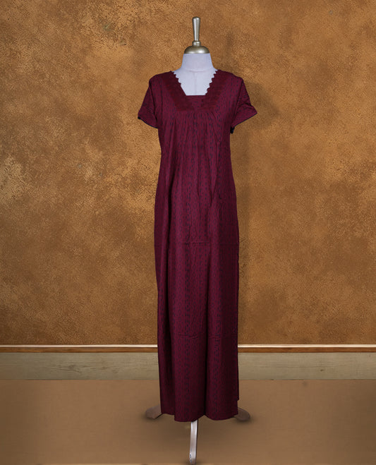 Dark red colour NStyle nighty featuring black patterns, a V-neckline with thread lace detailing, short sleeves, and a full ankle-length design.