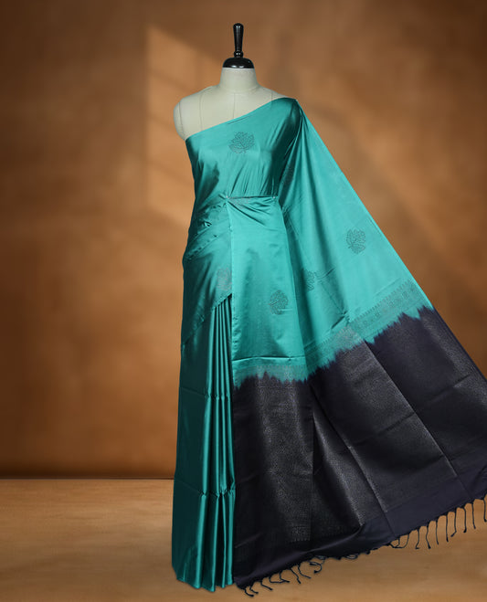 Teal colour soft silk saree featuring Antique zari motifs on body with Highlighting contrast Plum purple colour pallu and paired with matching blouse piece.