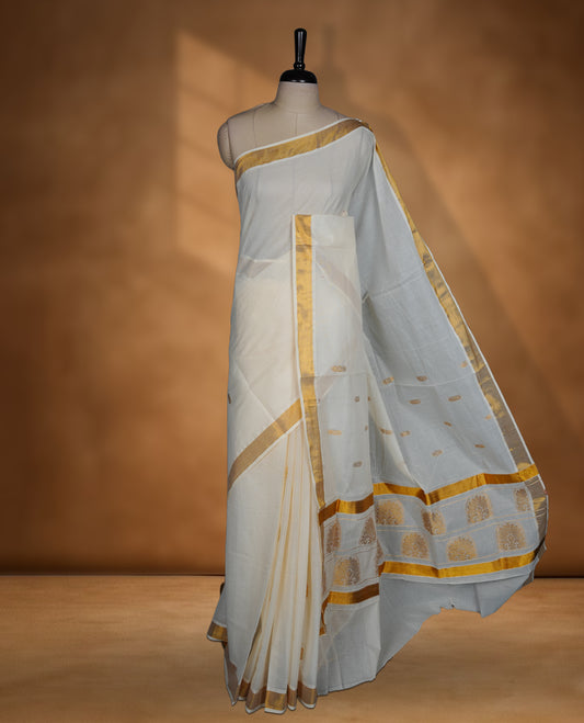 Off white colour cotton Kerala saree featuring a Plain body, an intricately woven traditional border with patterns on pallu, paired with a matching blouse.