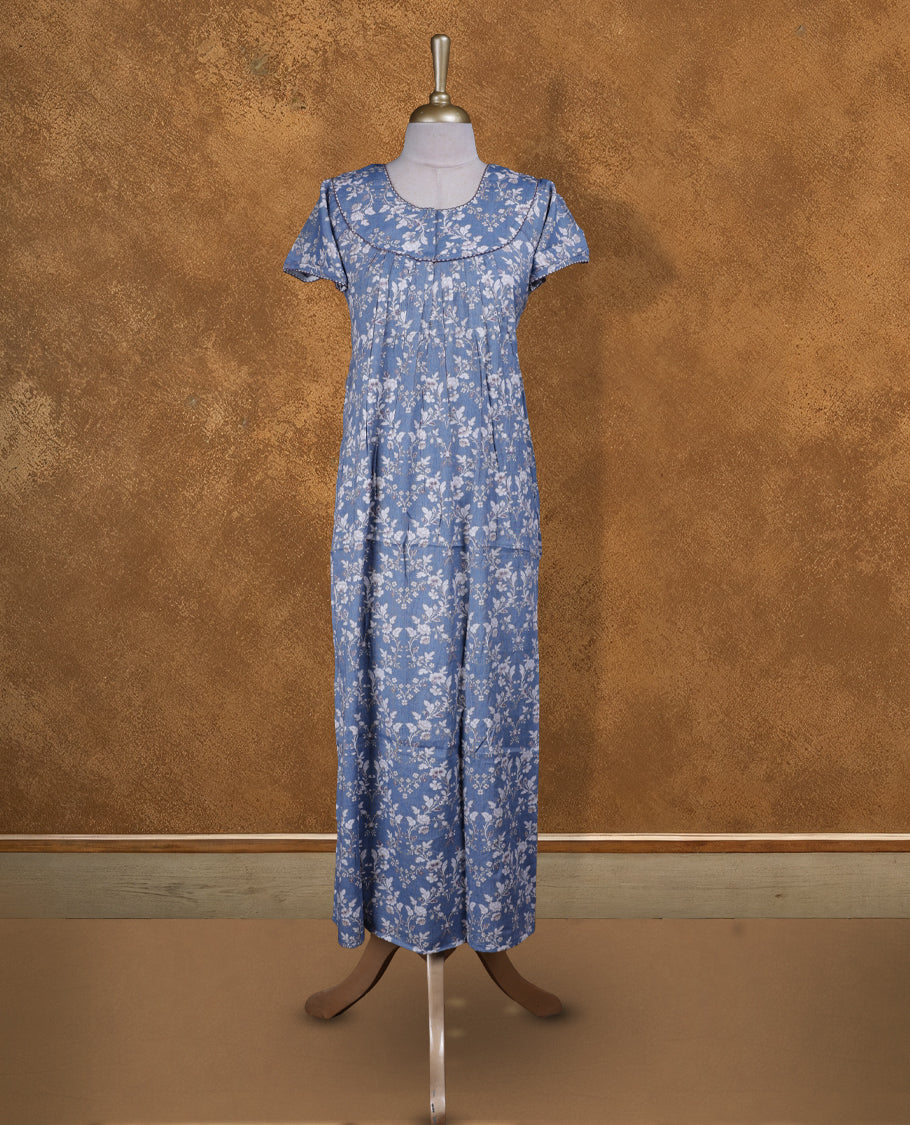 Sky blue colour NStyle nighty featuring White floral patterns, a Round neckline and thread border, short sleeves, and a full ankle-length design.