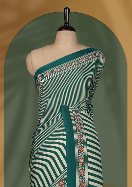 Teal and cream colour saree with bold stripes and geometric circle motifs, accentuated by a detailed ethnic border & paired with matching blouse.