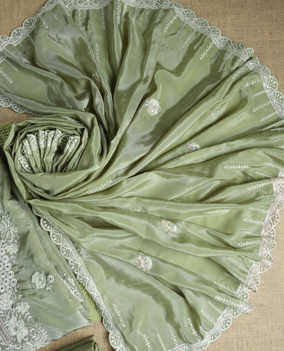 Pastel green colour suit material adorned with elegant white thread , cut beads & sequin embroidery, highlighted by a delicate lace border & Paired with a matching embroidered dupatta and plain bottom.