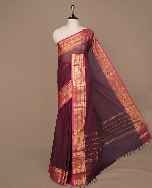 Maroon colour chettinad cotton saree featuring elegant plain body, complemented by contrast magenta colour with gold zari border, paired with matching blouse piece.