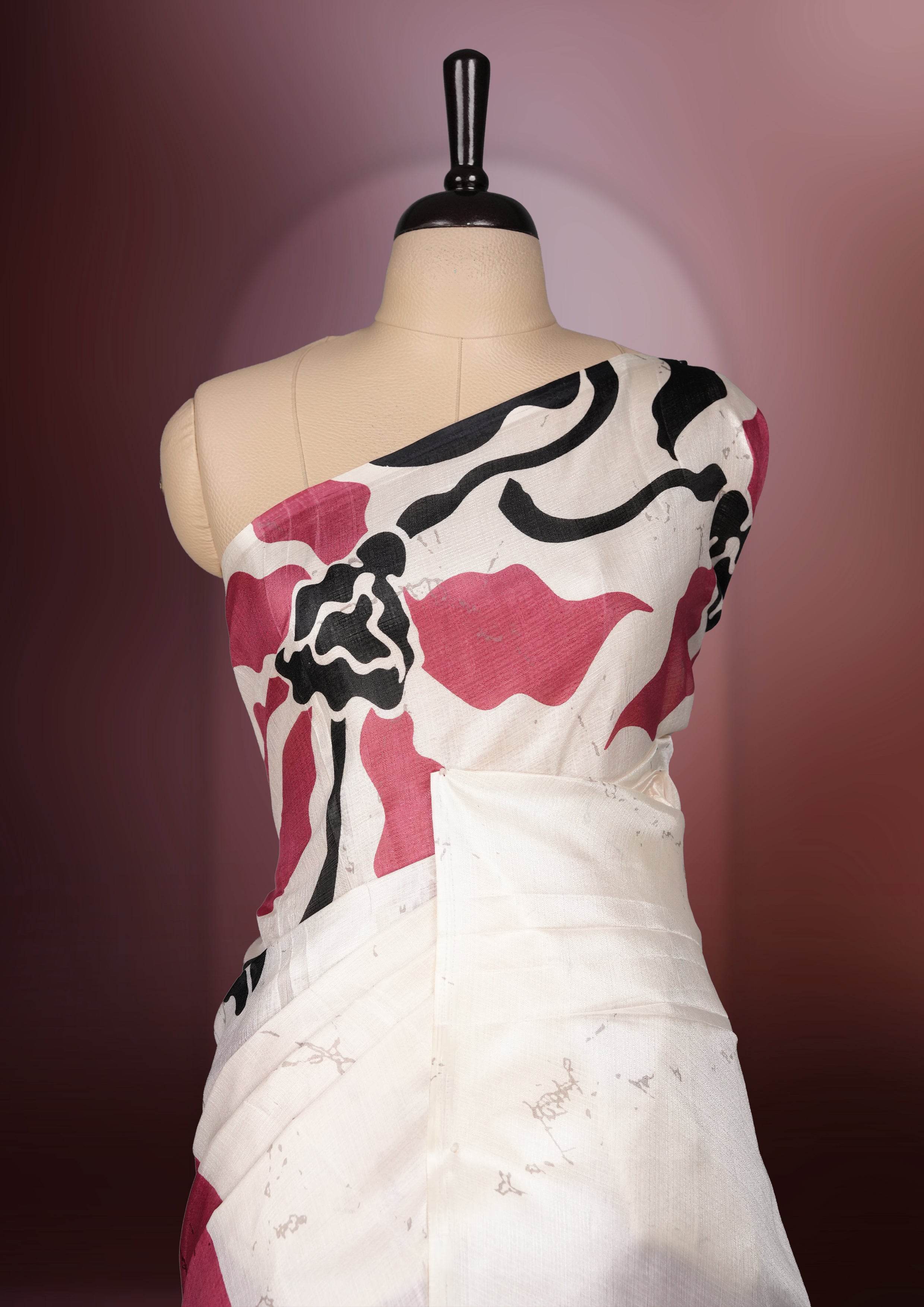 Dark onion pink colour saree with striking off white, black floral patterns, merging modern minimalism with timeless charm & paired with a matching blouse.