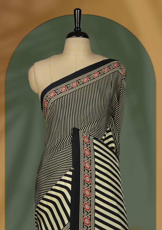 Black and beige colour striped saree with red floral embroidered border and abstract beige pallu detailing & Paired with a matching blouse.