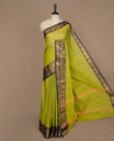 Olive green colour chettinad cotton saree featuring small buttas on body, complemented by contrast blue colour with gold zari border, paired with matching blouse piece.