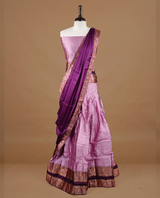 Pink colour semi stitched Half saree featuring contrast Deep purple colour with gold zari traditional border skirt, paired with matching zari border dupatta, unstitched blouse piece