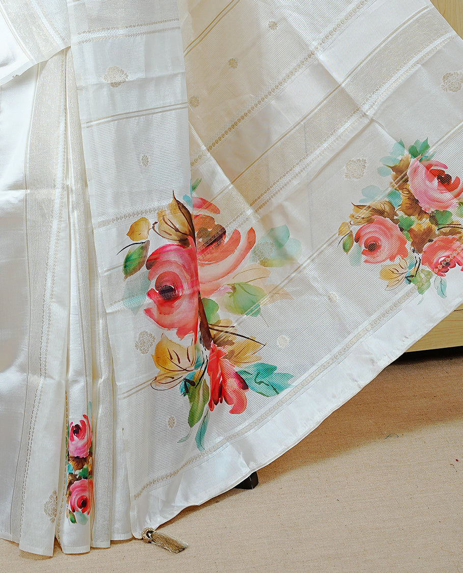 Cream Colour Organza Kerala Saree Featuring Digital Rose Floral Prints Across The Body, Enhanced With Subtle Light Gold Zari Stripes And A Light Gold Zari Border, Finished With Gold Tassels And A Matching Blouse Piece