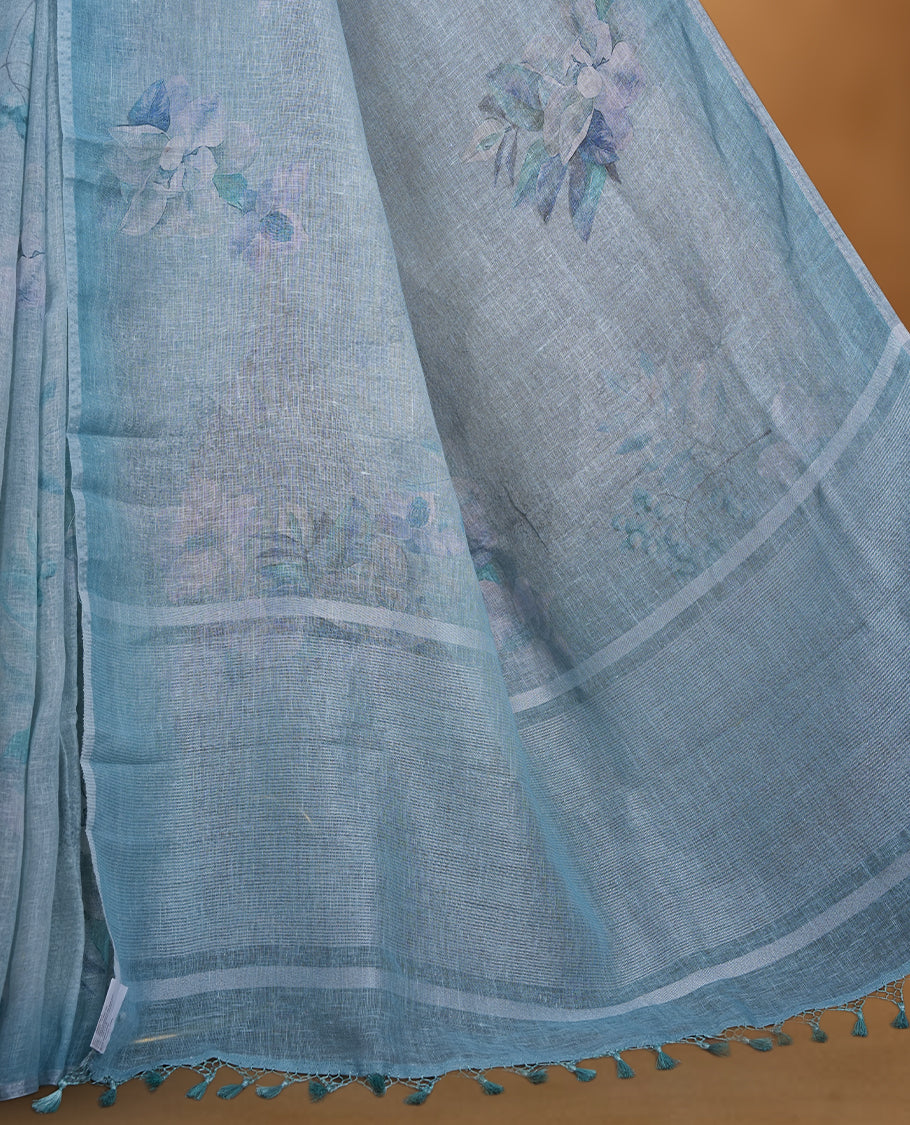 Light blue colour pure linen saree featuring Floral print pattern across body, silver thin border finished with matching blouse.