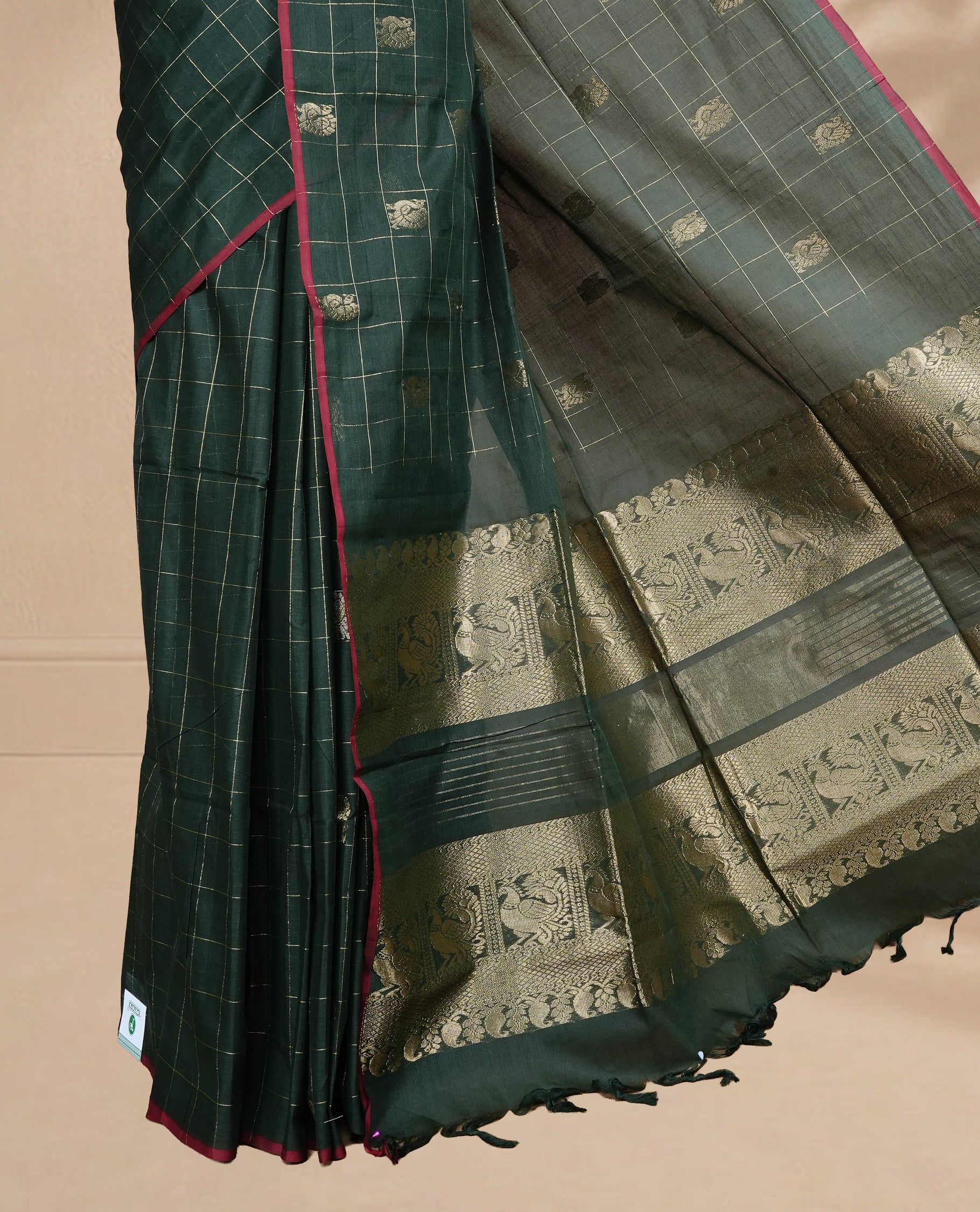 Green colour chettinad cotton saree featuring Gold zari check with Peacock motifs on body, complemented by Red colour piping border, paired with matching blouse.