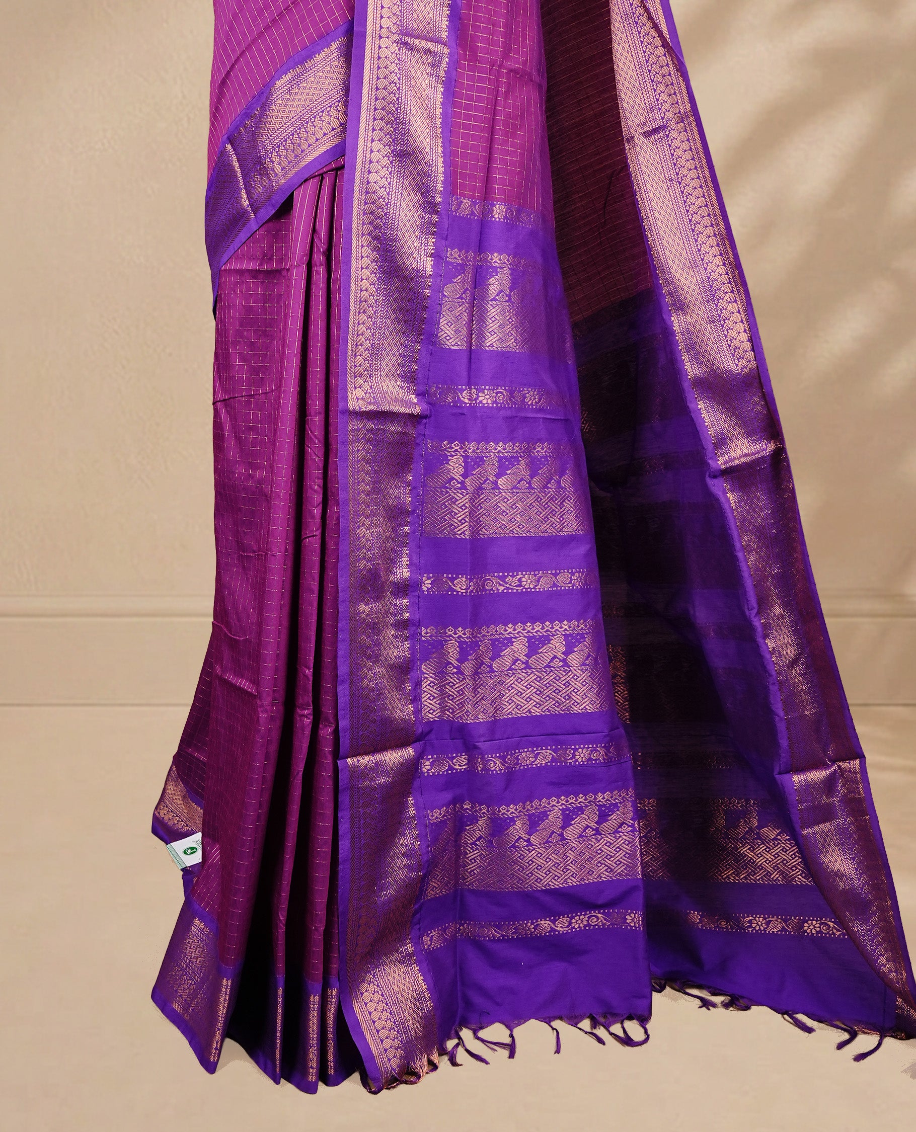 Purple colour kalyani cotton saree featuring gold zari check pattern on body, complemented by Violet colour with Antique zari border, paired with matching blouse piece.