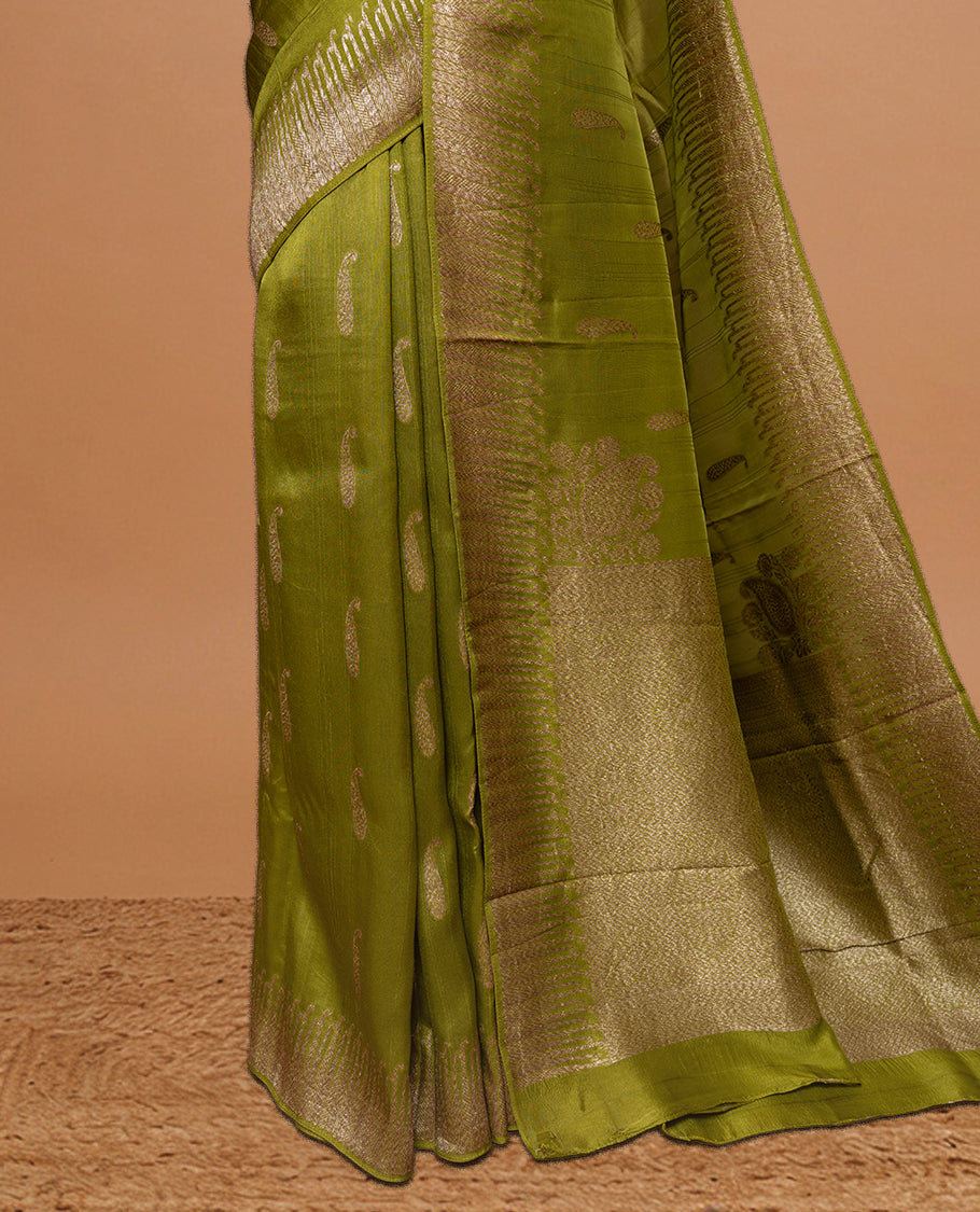 Olive colour Semi Banaras Tussar Georgette Featuring Gold zari Leaf pattern on body, Finished with Gold zari border and paired with matching blouse piece.