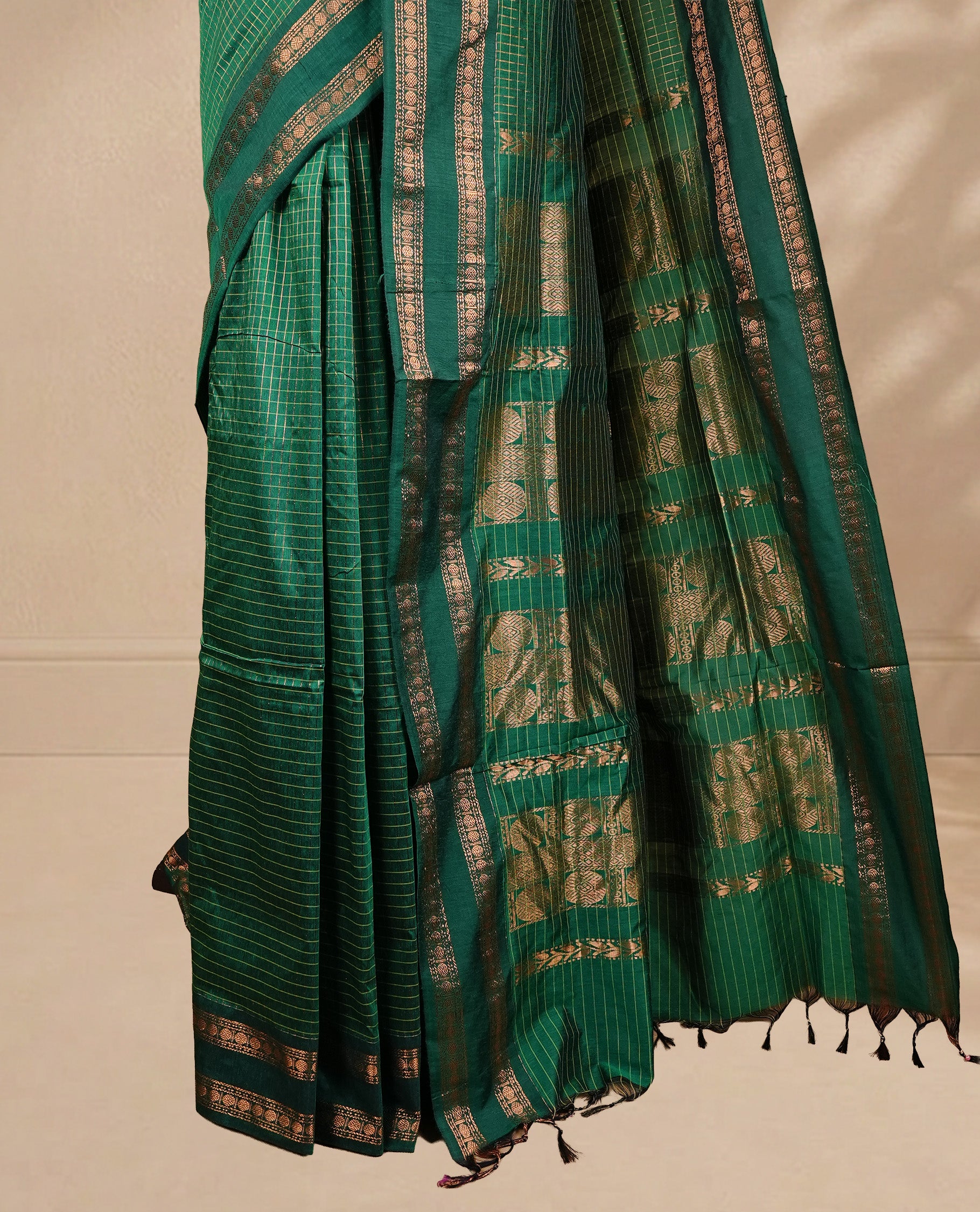 Green colour kalyani cotton saree featuring gold zari check pattern on body, complemented by Self colour with Antique zari border, paired with matching blouse piece.