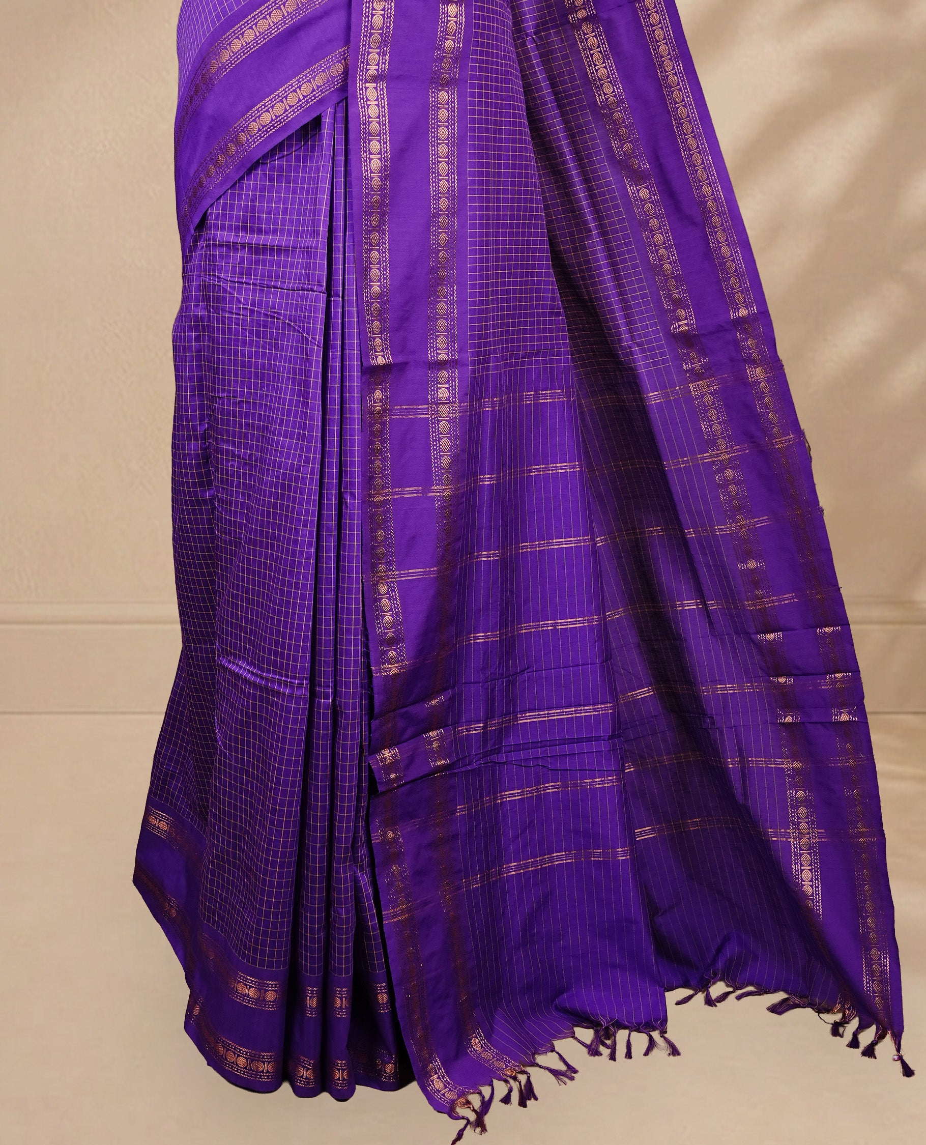 Indigo colour kalyani cotton saree featuring gold zari check pattern on body, complemented by Self colour with Antique zari border, paired with matching blouse piece.