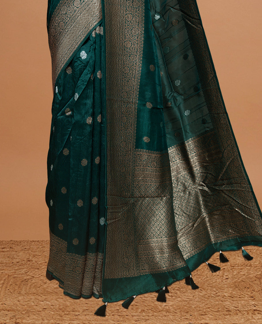 Green colour Semi banaras tussar georgette Saree featuring Antique zari motifs on body, enhanced with antique zari border, paired with a matching blouse piece.