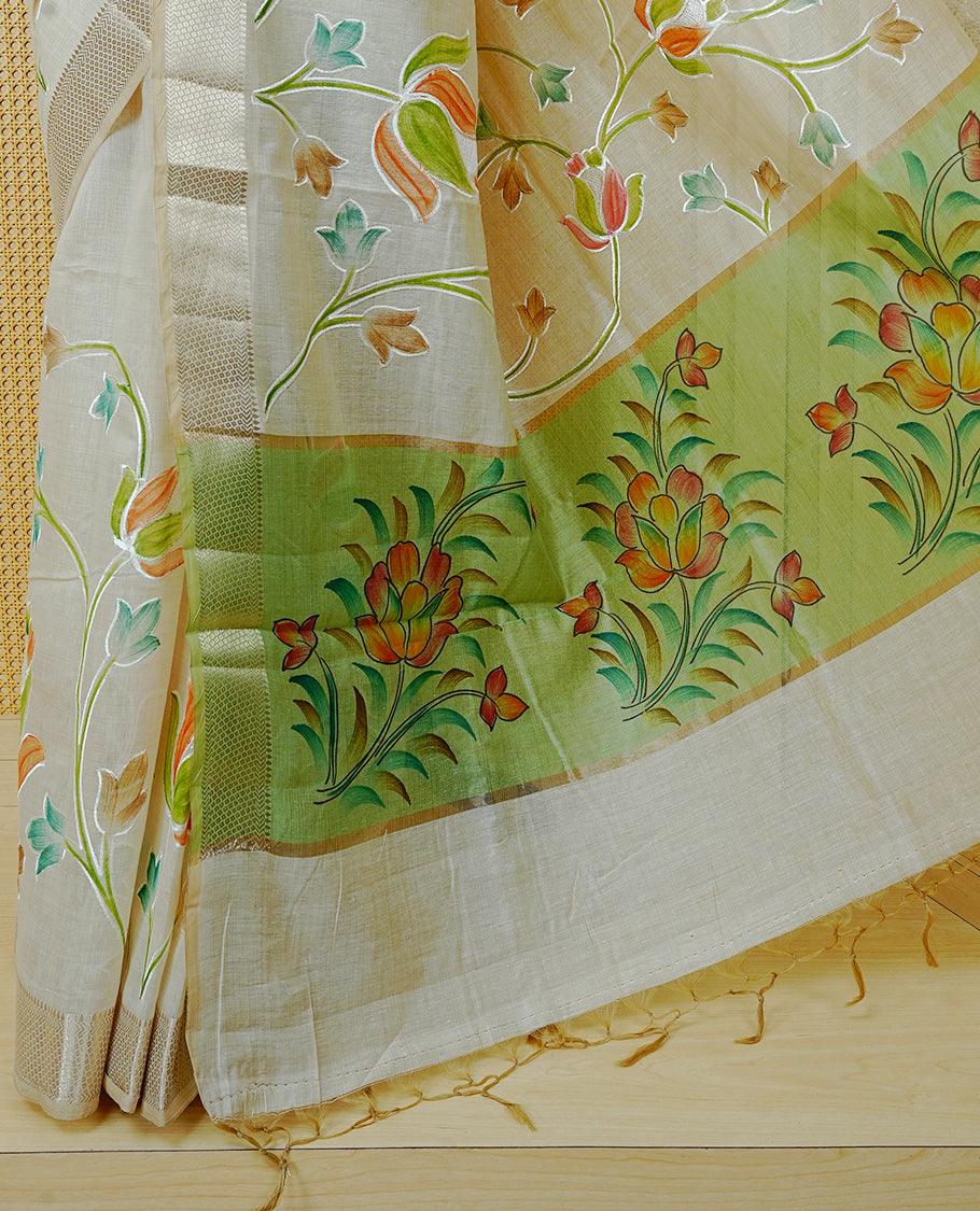 Cream Colour Tissue Kerala Saree Featuring Floral Kodi Threadwork Across The Body, Enhanced With A Light Gold Zari Border And A Light Green Floral Pallu, Finished With Gold Tassels And A Matching Blouse Piece
