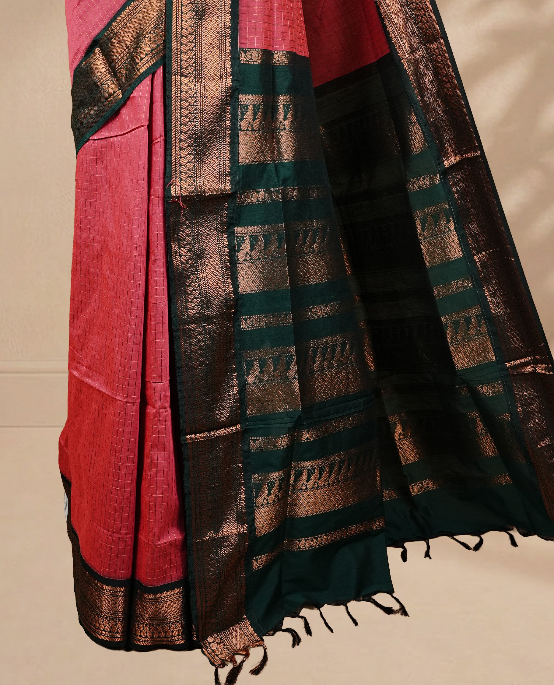 Pinkish peach colour kalyani cotton saree featuring gold zari check pattern on body, complemented by green colour with Antique zari border, paired with matching blouse piece.