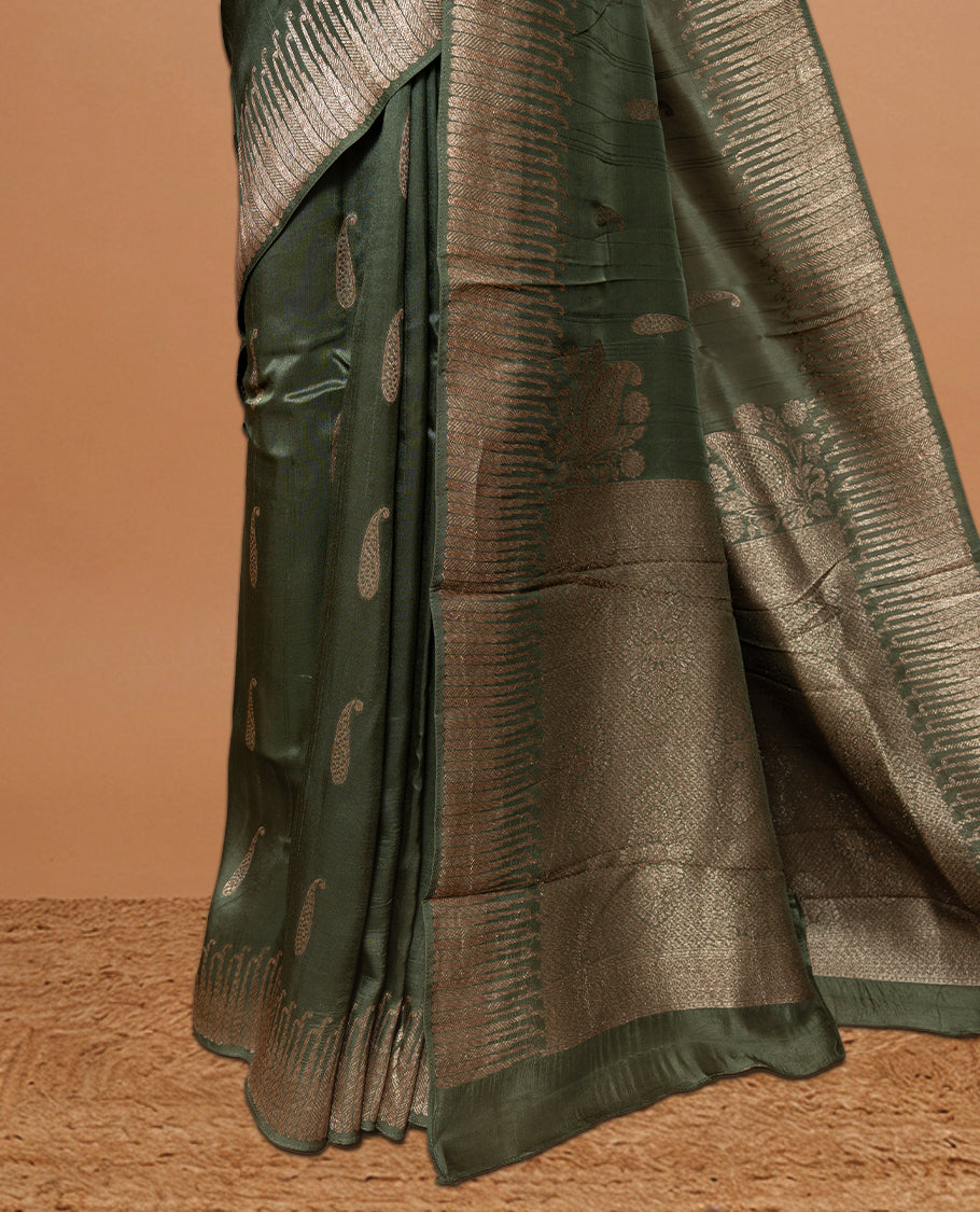 Green colour Semi Banaras Tussar Georgette Featuring Gold zari Leaf pattern on body, Finished with Gold zari border and paired with matching blouse piece.