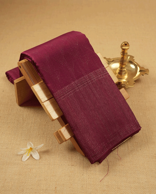 Dark Maroon coloured Manthrakodi saree featuring a multicoloured zari jacquard body, complemented by a self coloured turning Banarasi border and a matching self coloured blouse.